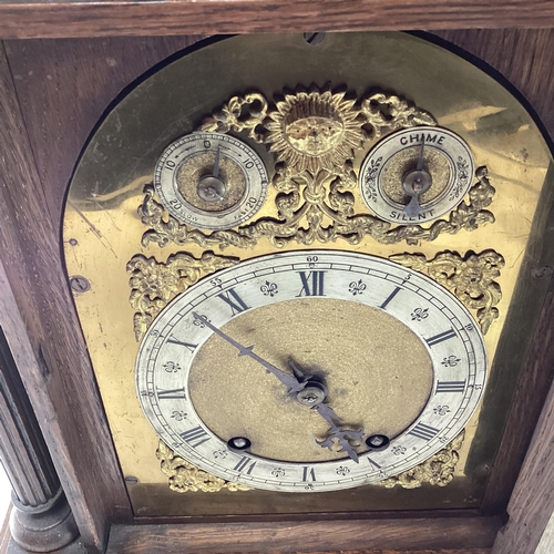 350 - C19th Oak cased mantle clock of large proportions, arched dial with silver chapter ring, gilt spandr... 