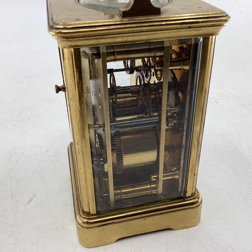 353 - A Swiss gilt brass carriage clock, with visible escapement stamped made in Switzerland 17cm (in hand... 