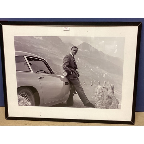 369 - A large photographic print of Sean Connery, leaning against his Aston Martin DB5, screen shot from t... 