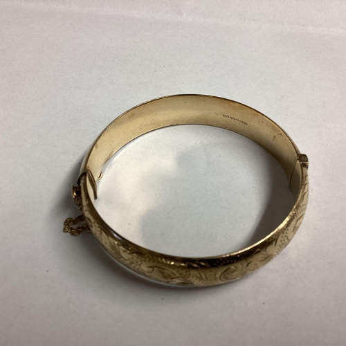 44 - 9ct gold bangle bracelet with chased decoration 16g