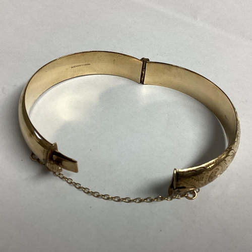 44 - 9ct gold bangle bracelet with chased decoration 16g