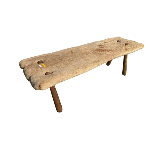 461 - A large rustric wooden pig bench on later tapered splayed supports (signs of previous old worm), 145... 