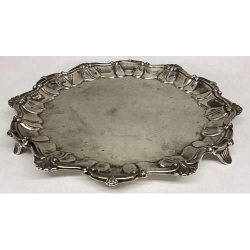 48 - A Sterling silver circular card tray with scalloped edge on three feet, 324g, 22cm diam, by Lee & Wi... 