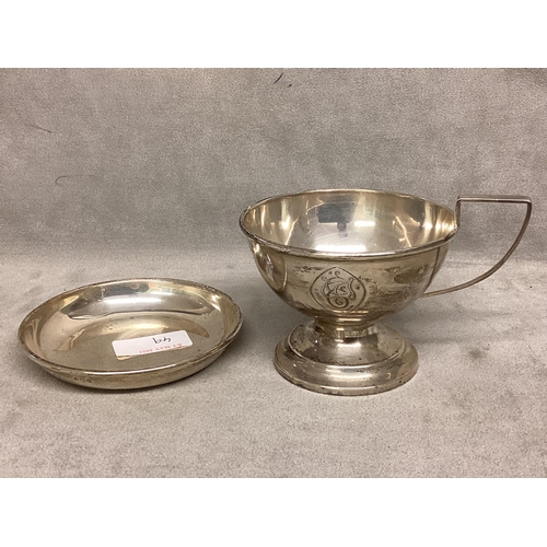 49 - A Sterling silver cup, circular stepped base, loop handle, together with an unmarked white metal pin... 