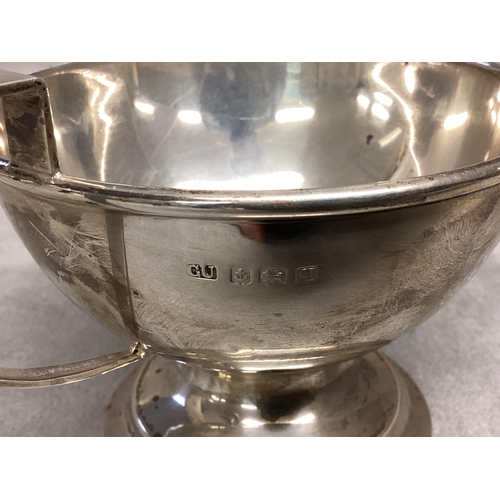 49 - A Sterling silver cup, circular stepped base, loop handle, together with an unmarked white metal pin... 