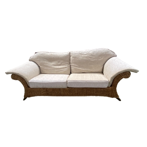 492 - A good  large rattan conservatory sofa with fitted upholstered cream cushions, 215 x 98 x 92cm, some... 