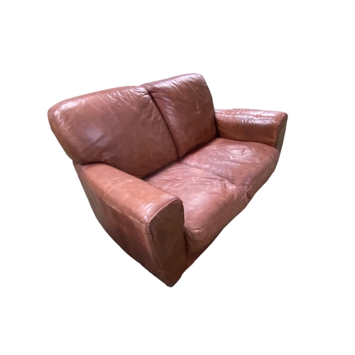 493 - A good brown leather two seater sofa on square wooden feet, 50 x 89 x 92