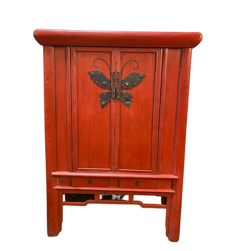 502 - A C19th style Chinese red lacquer Wedding Cabinet with butterfly escutcheons with two drawers below ... 