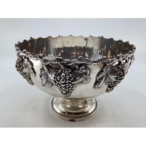 58 - Large silver plated punch bowl with cast grape and vine decoration on circular reeded foot by Walker... 