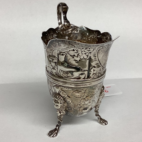 6 - A Sterling silver cream jug, decorated with repousse farmyard scenes on 3 paw feet by John Millward ... 