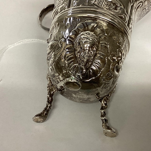 6 - A Sterling silver cream jug, decorated with repousse farmyard scenes on 3 paw feet by John Millward ... 