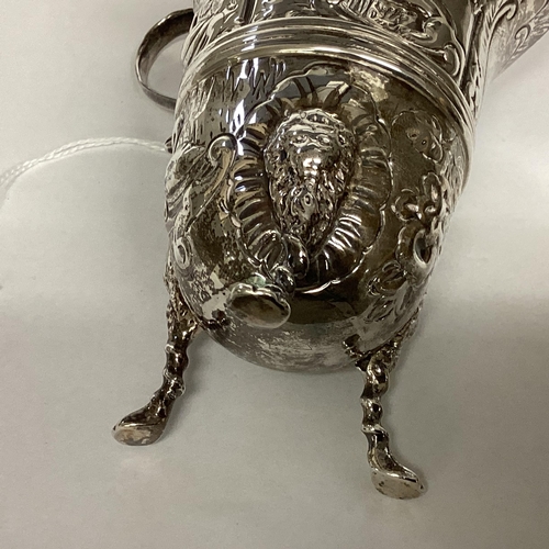 6 - A Sterling silver cream jug, decorated with repousse farmyard scenes on 3 paw feet by John Millward ... 