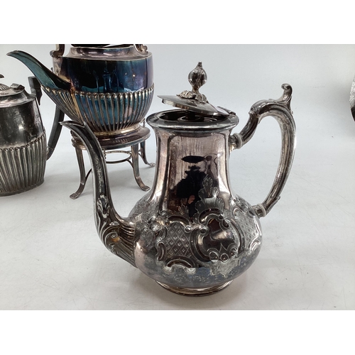 63 - Collection of silver plated wares to include kettle on burner, ornately decorated teapot and small g... 