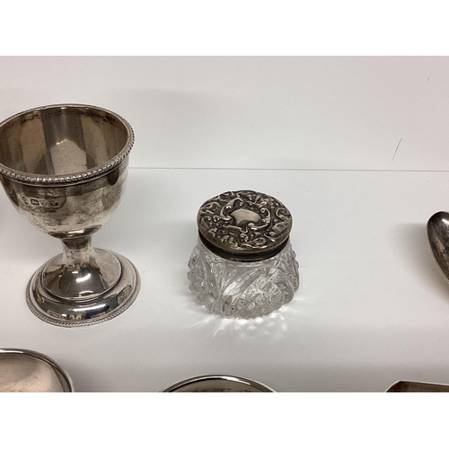 87 - Collection of Sterling silver items to include napkin rings, egg cup, 216g silver, and a silver hand... 