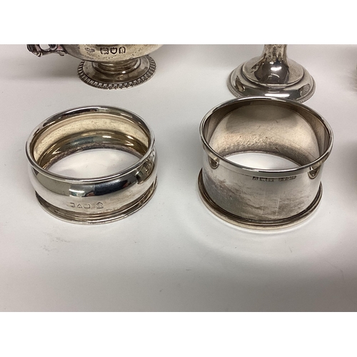 87 - Collection of Sterling silver items to include napkin rings, egg cup, 216g silver, and a silver hand... 