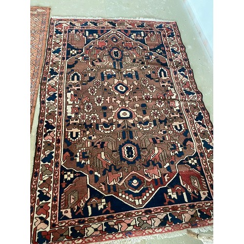 393 - Two Rugs, A North West Persian Hamadan Rug and a Turkmen Bokhara rug: both with some wear