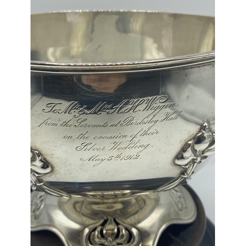 10 - Sterling Silver circular bowl with raised floral decoration, on a turned wooden base, Elkington & Co... 