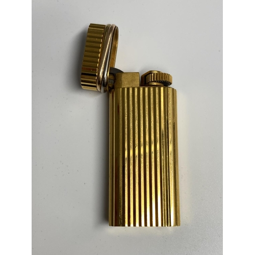 106 - A Cartier Gold plated lighter in red tooled Cartier Box