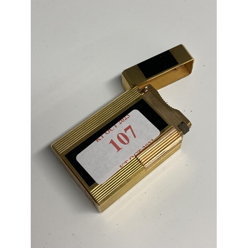 107 - A Dupont gold plated and black enamel lighter with red Chinese calligraphy