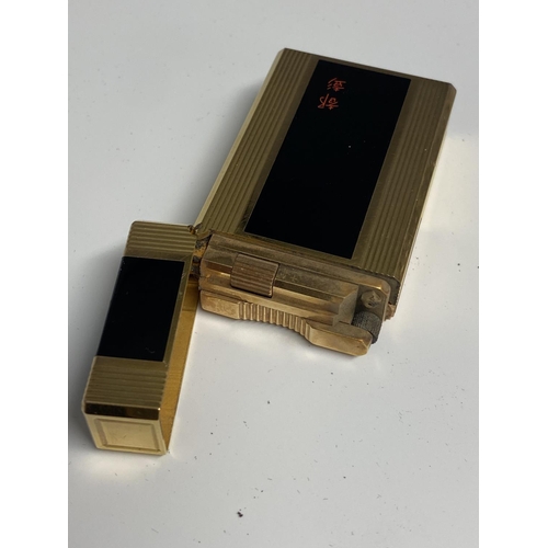 107 - A Dupont gold plated and black enamel lighter with red Chinese calligraphy