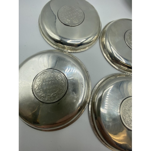 12 - A set of 4 silver coin set pin dishes and a sterling silver example and 2 unmarked white metal Middl... 