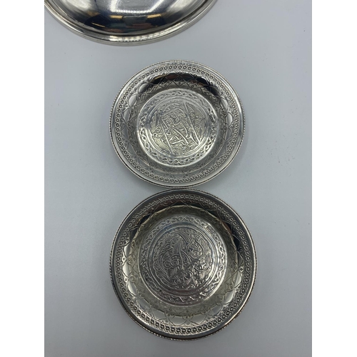 12 - A set of 4 silver coin set pin dishes and a sterling silver example and 2 unmarked white metal Middl... 