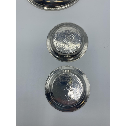 12 - A set of 4 silver coin set pin dishes and a sterling silver example and 2 unmarked white metal Middl... 