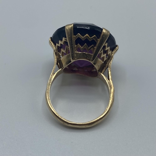 20 - A 9ct gold dress ring, single circular free cut amethyst coloured paste stone in a six claw setting,... 