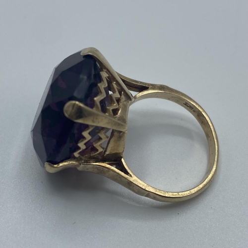 20 - A 9ct gold dress ring, single circular free cut amethyst coloured paste stone in a six claw setting,... 