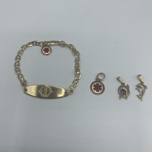 35 - A 10ct gold marked ID bracelet with 9ct and 10ct charms  12.5g