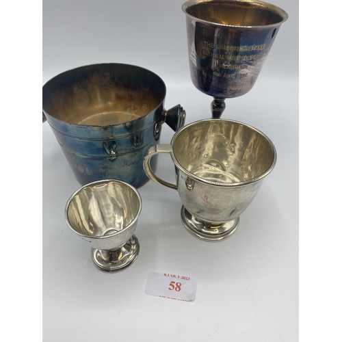 58 - A sterling silver christening cup together with a sterling silver egg cup 120g together with two pla... 