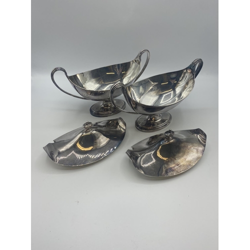 69 - A pair of sterling silver Adams style lidded sauce tureens by CJ Vander London 1962. 32ozt. Approx