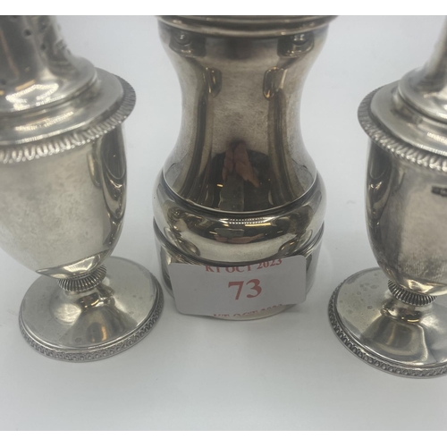 73 - A pair of Adams style pepperettes together with a sterling silver pepper grinder.