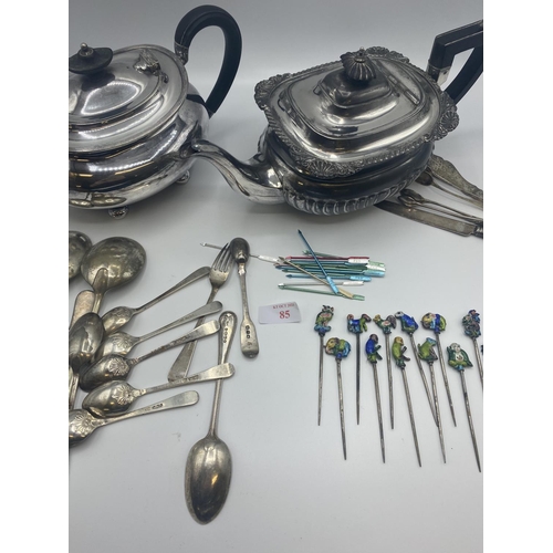 85 - Quantity of silver teaspoons, and two silver plate teapots, and cocktail sticks