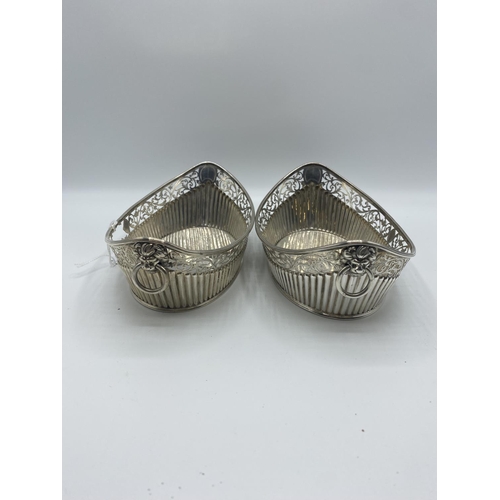 9 - Pair of Sterling Silver pierced oval baskets with lion and ring handles, Sheffield, 1885, 516g, some... 