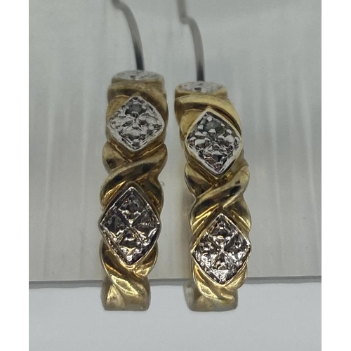 95 - A pair of diamond ear studs together with a pair of yellow metal hoop earrings.