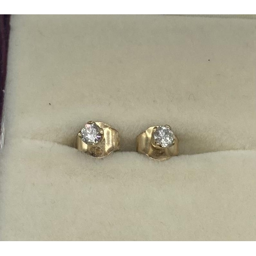 95 - A pair of diamond ear studs together with a pair of yellow metal hoop earrings.