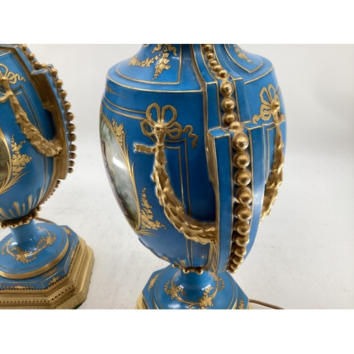 216 - A pair of Continental Meissen Style lamps, on stepped gilded base, the blue body with central oval p... 