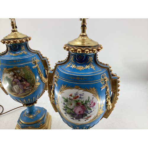 216 - A pair of Continental Meissen Style lamps, on stepped gilded base, the blue body with central oval p... 