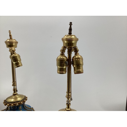 216 - A pair of Continental Meissen Style lamps, on stepped gilded base, the blue body with central oval p... 