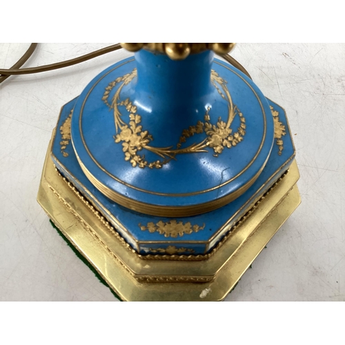 216 - A pair of Continental Meissen Style lamps, on stepped gilded base, the blue body with central oval p... 