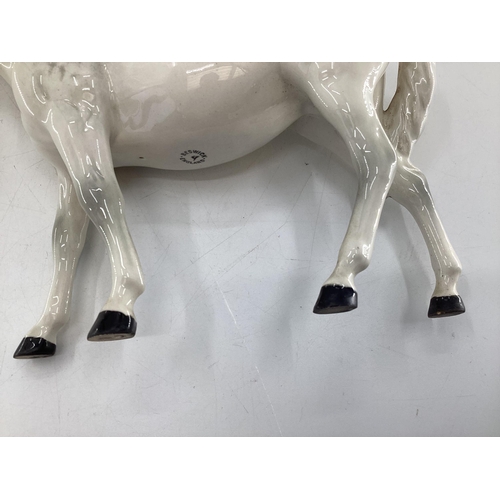 222 - A Beswick model of a dapple grey mare and bay foal on an oblong base ; together with a Beswick grey ... 