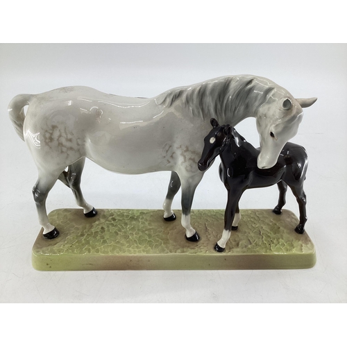 222 - A Beswick model of a dapple grey mare and bay foal on an oblong base ; together with a Beswick grey ... 