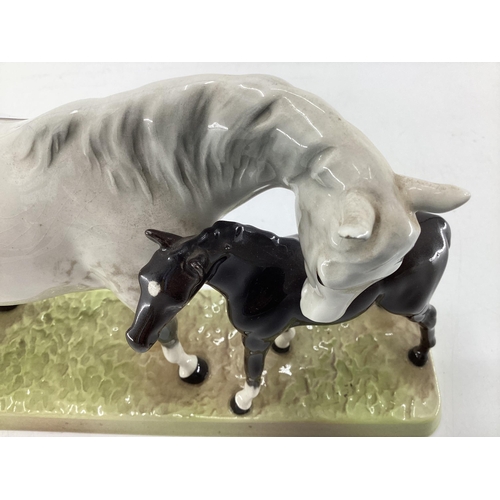 222 - A Beswick model of a dapple grey mare and bay foal on an oblong base ; together with a Beswick grey ... 