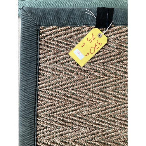 676 - A sisal runner rug, 370 x 75cm, with grey material edging