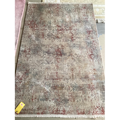 678 - Two modern rugs, pink by Laura Ashley (some wear), 140 x 200cm; and cream ground rug labelled Gooch ... 