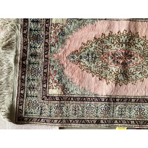 679 - A Tabriz style rug, silk and wool pink central ground  89 x 155cm