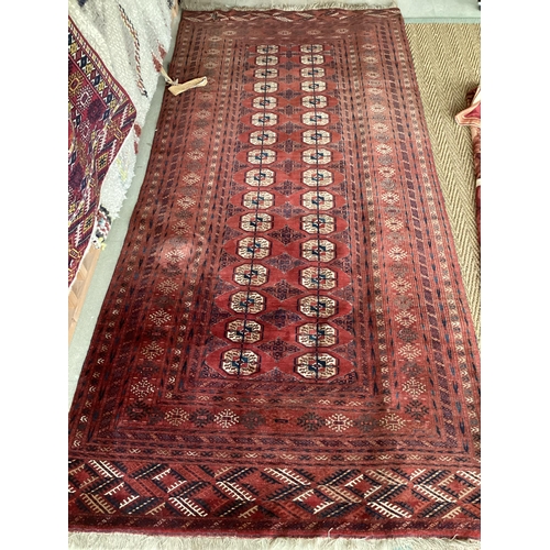 680 - Persian style rug, red ground, with tears and losses 130cm x 295cm]