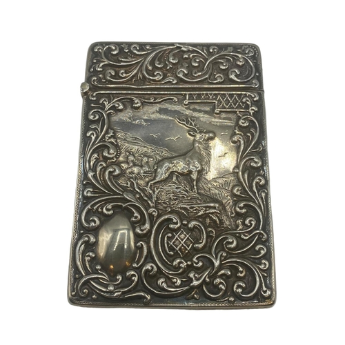 99 - Two sterling silver card cases, one with a stag in a landscape, vacant cartouche, scrolling surround... 