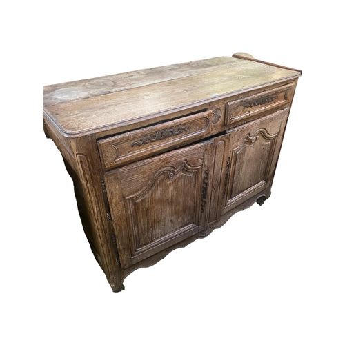 661 - A C19th French oak rustic sideboard, with 2 short drawers over two cupboard doors, with much wear an... 